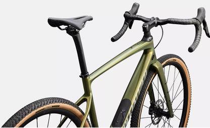 Close up view of olive green Specialized road bicycle with black components on a light gray background.