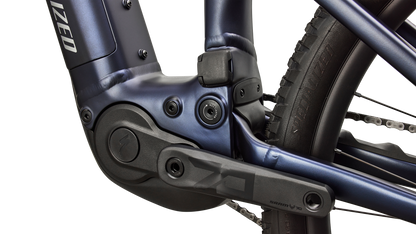 A close up view of the motor and crank of a blue Specialized Levo R Comp Alloy electric assist mountain bike.