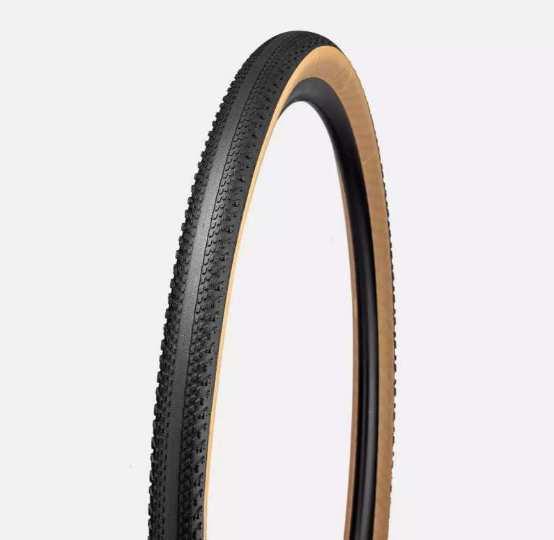 The Specialized Pathfinder TLR Fast Gravel Tire has a black tread with a smooth center and ridges for cornering and a tan sidewall.