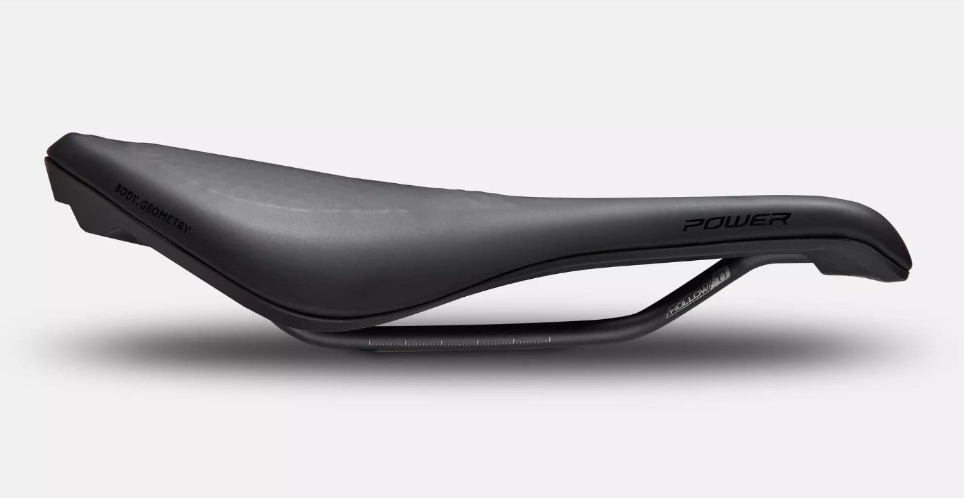 Side profile view of black Specialized Power Expert bicycle saddle on a white background. 