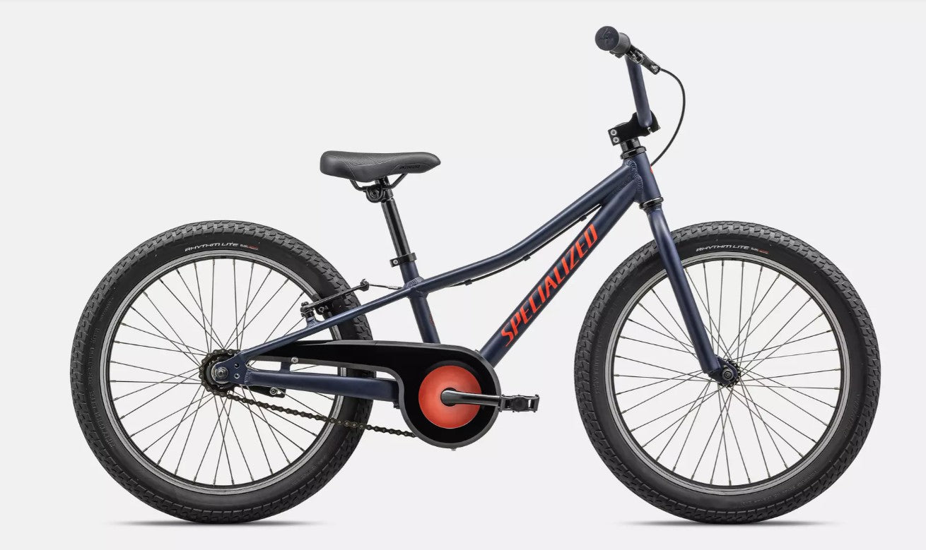Right profile view of a dark blue Specialized Riprock kids bicycle with  red lettering and black components on a white background. 