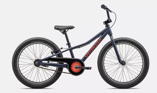 Right profile view of a dark blue Specialized Riprock kids bicycle with  red lettering and black components on a white background. 