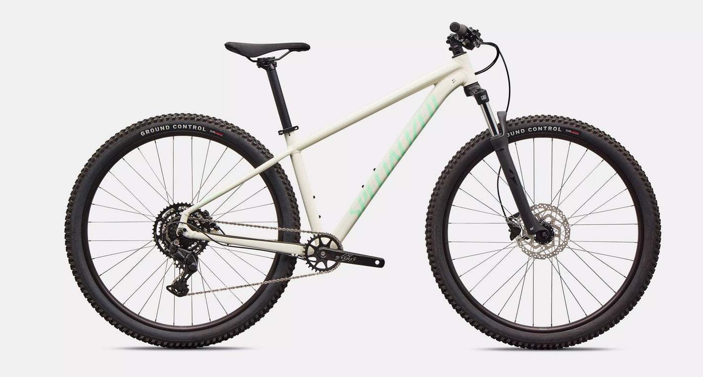 White Specialized Rockhopper Sport mountain bike with black components on a light gray background