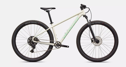 White Specialized Rockhopper Sport mountain bike with black components on a light gray background