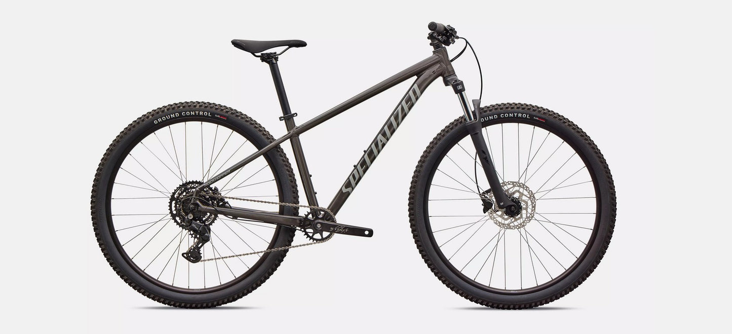 Profile of dark grey Specialized Rockhoper Sport mountain bike on a white background