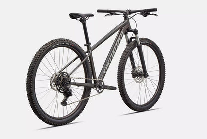 Dark grey Specialized Rockhopper mountain bike on a white background.