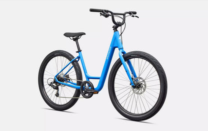 Front right profile view of blue Specialized Roll bicycle with white lettering and black components on white background. 
