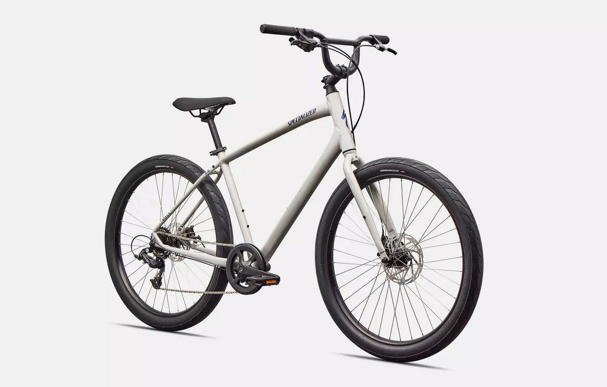 Front right profile view of white Specialized Roll bicycle with blue lettering and black components on a white background. 