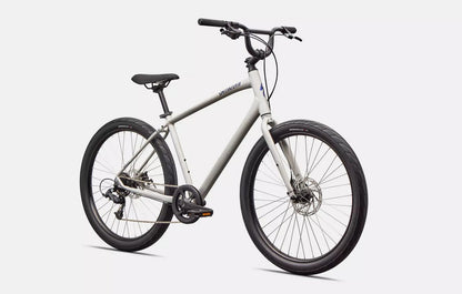 Front right profile view of white Specialized Roll bicycle with blue lettering and black components on a white background. 