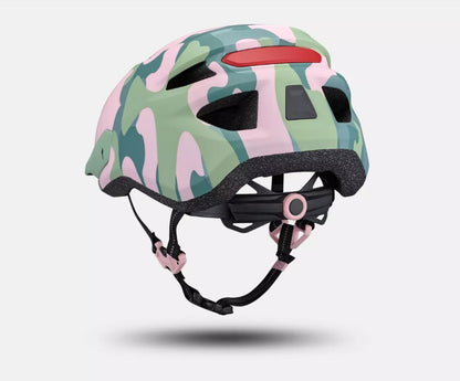Side angled view of a pink and green camouflage patterned Specialized Shuffle LED 2 child's bicycle helmet on a white background. 