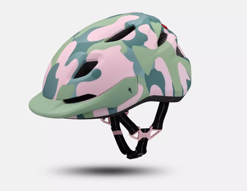 Side view of a pink and green camouflage patterned Specialized Shuffle LED 2 child's bicycle helmet on a white background. 