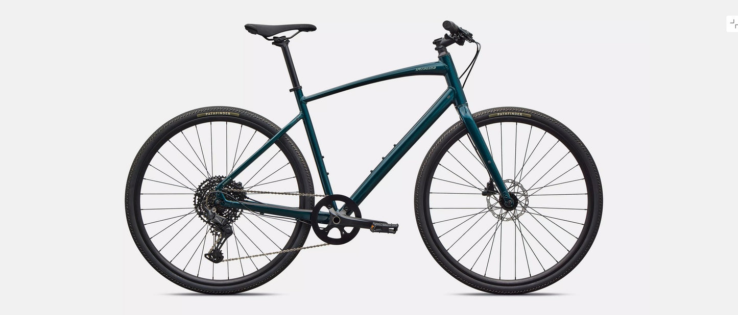 Right profile of emerald green Specialized Sirrus X bicycle  with black components on a light gray background