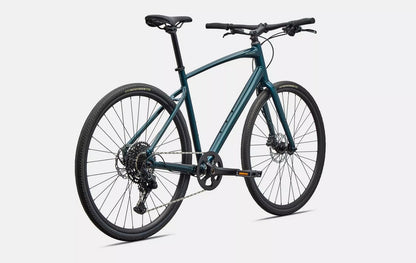 Back right view of emerald green Specialized Sirrus X bicycle with black components on a white background