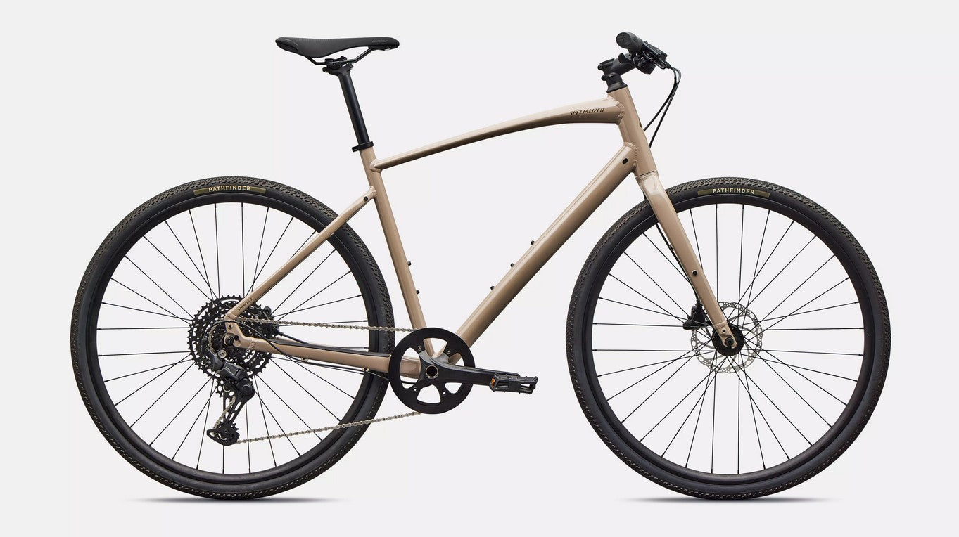 Right profile of beige Specialized Sirrus X bicycle with black components  on a white background