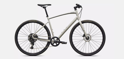 Right profile view of white Specialized Sirrus X bicycle with black components on a white background. 