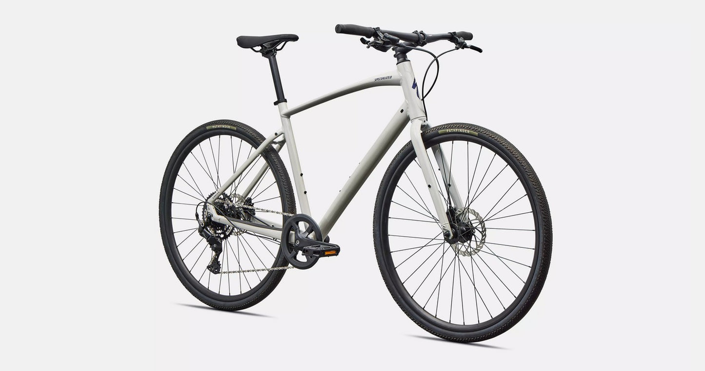 Front right profile view of a white Specialized Sirrus X bicycle with black components on a white background. 