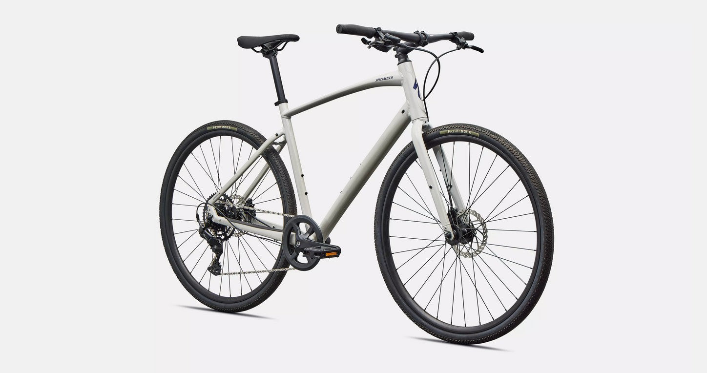 Front right profile view of a white Specialized Sirrus X bicycle with black components on a white background. 