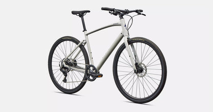 Front right profile view of a white Specialized Sirrus X bicycle with black components on a white background. 