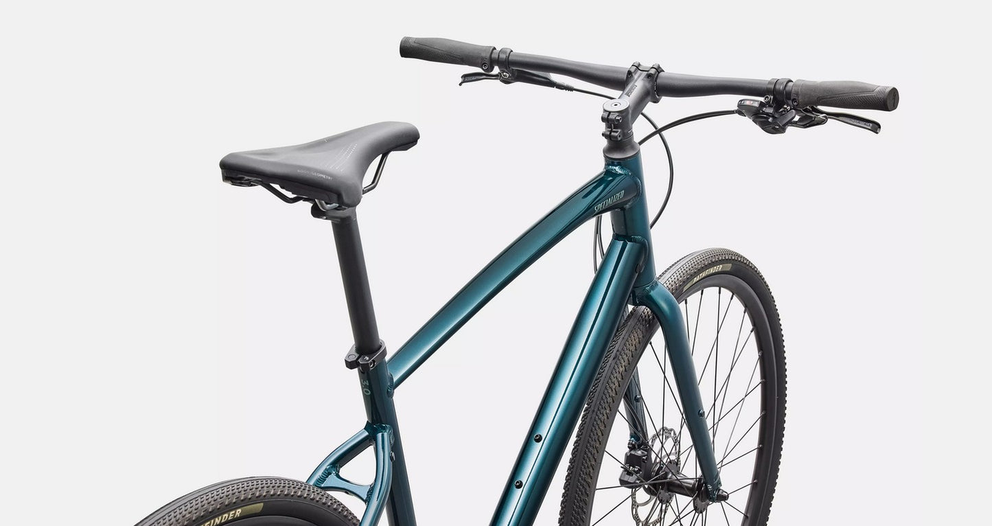 Close of up view of handlebars of emerald green bicycle with black components on a white background. 
