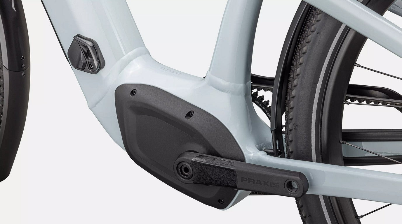 Close-up of a light blue Specialized Turbo Como bicycle's mid-drive motor on a white background