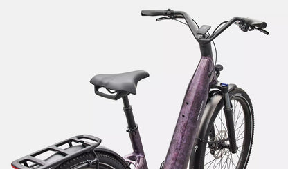 Purple Specialized Turbo Como electric bicycle with a black seat and rear rack on a white background