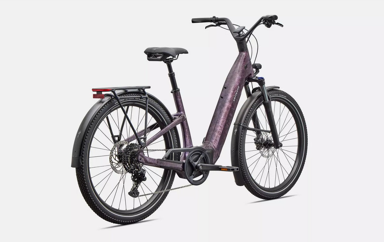 Back right profile view of purple Specialized Turbo Como electric bicycle with black components on a white background