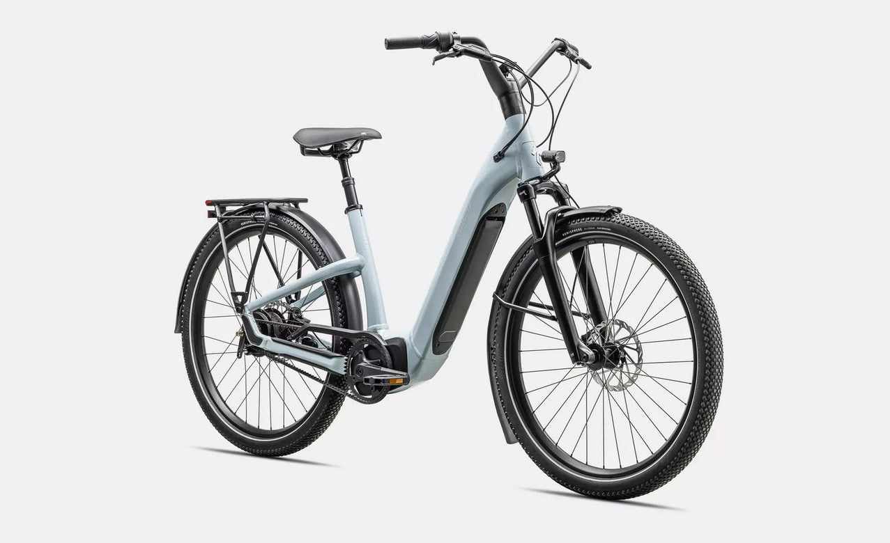 Light blue Specialized Turbo Como electric bicycle with black components on a white background.