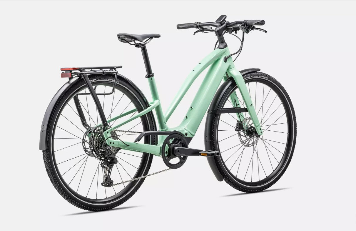 Back angled profile view of a light green Specialized Vado electric bicycle with black components on a white background. 