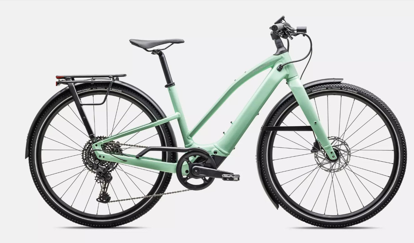 Right profile view of light green Specialized Vado SL electric bicycle with black components on a white background. 