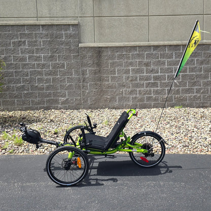View of the Spokes Fighting Strokes Logo Flag without Handicapped Symbol  on a trike in an outdoor setting.