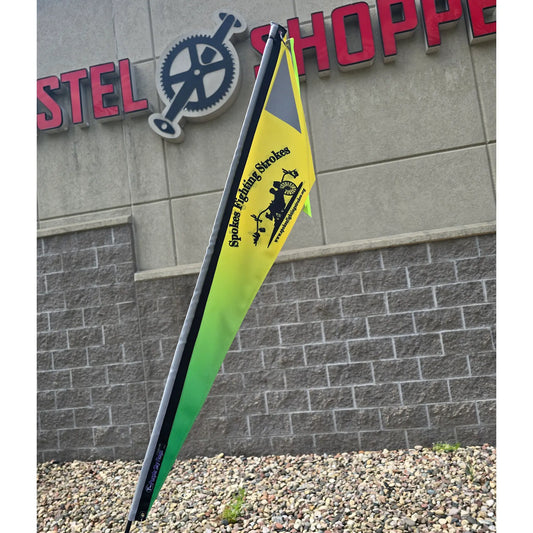 Closeup view of the Spokes Fighting Strokes Logo Flag without Handicapped Symbol in an outdoor setting.