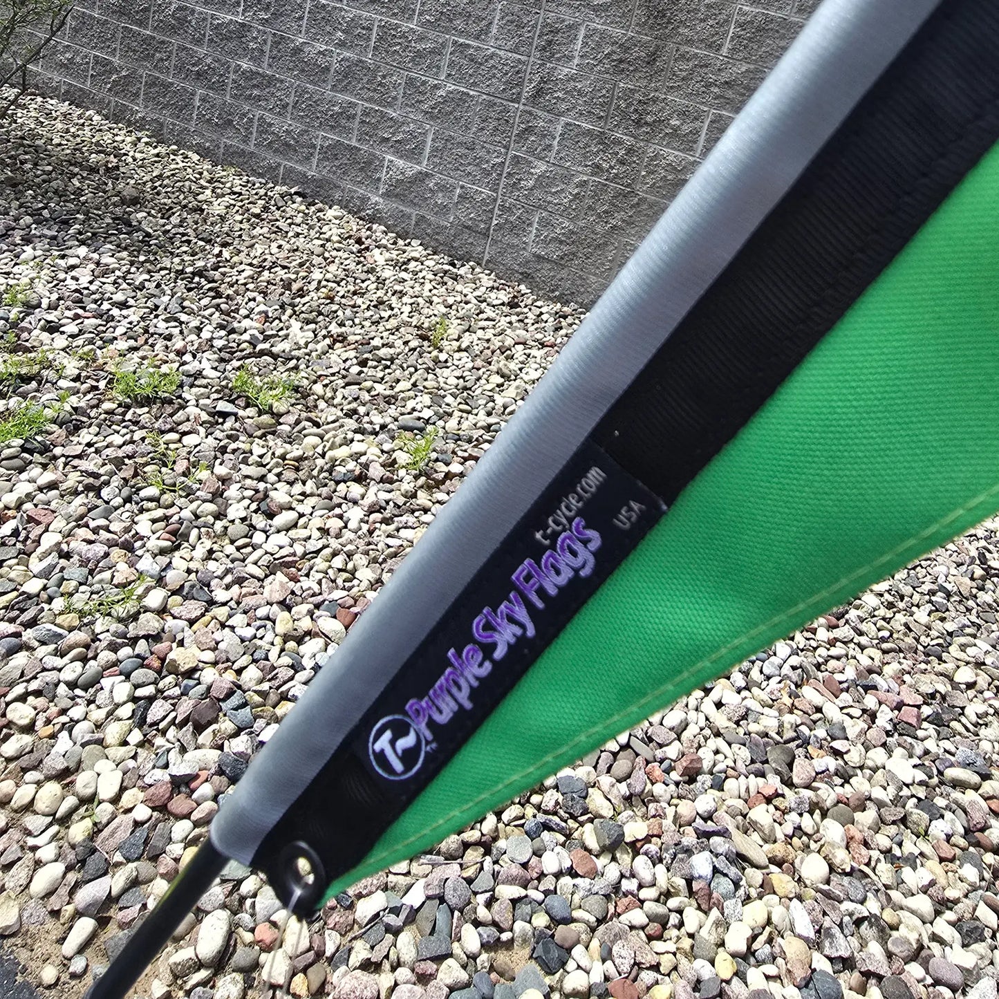 Closeup view of the Spokes Fighting Strokes Logo Flag made by T-Cycle Purple Sky Flags in the USA in an outdoor setting.