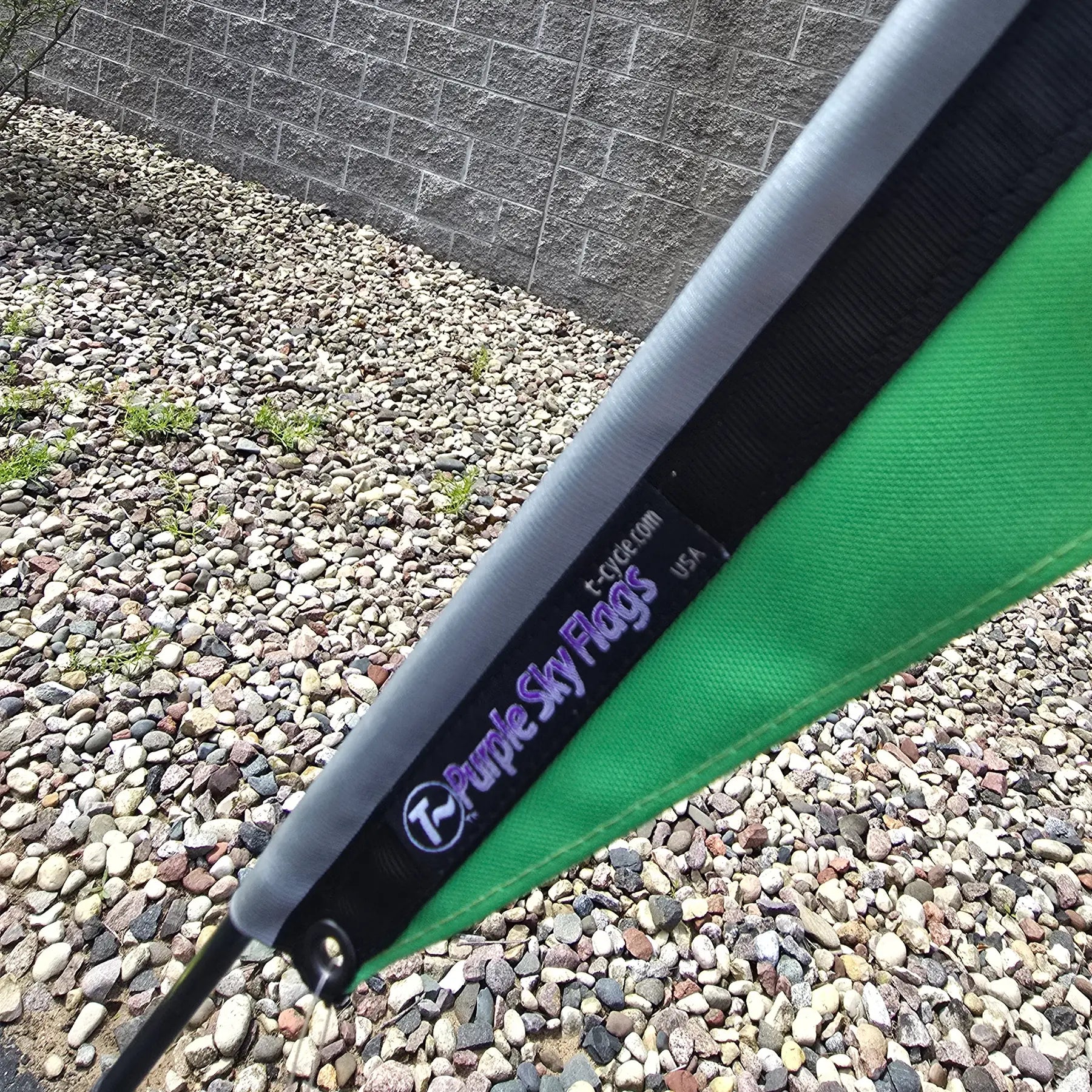 Closeup view of the Spokes Fighting Strokes Logo Flag made by T-Cycle Purple Sky Flags in the USA in an outdoor setting.