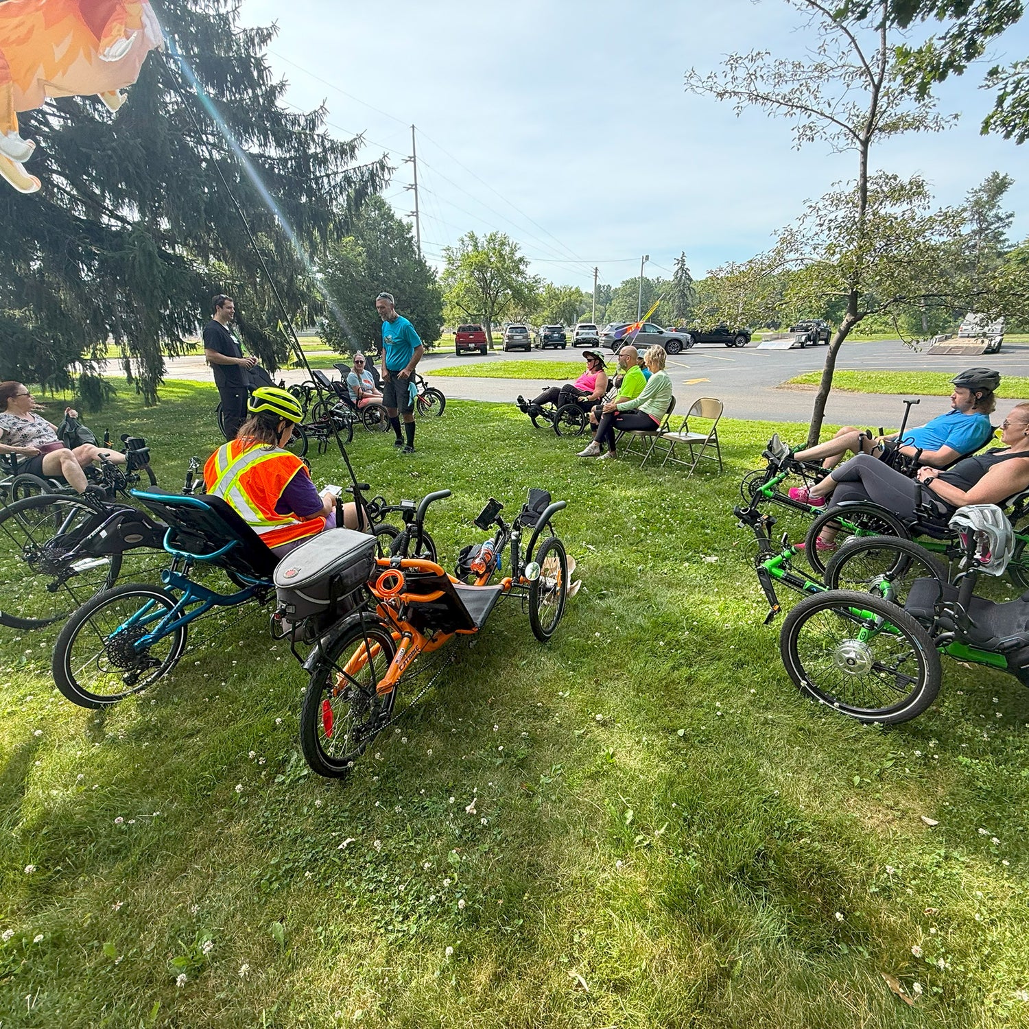 People with recumbent trikes in a park setting.