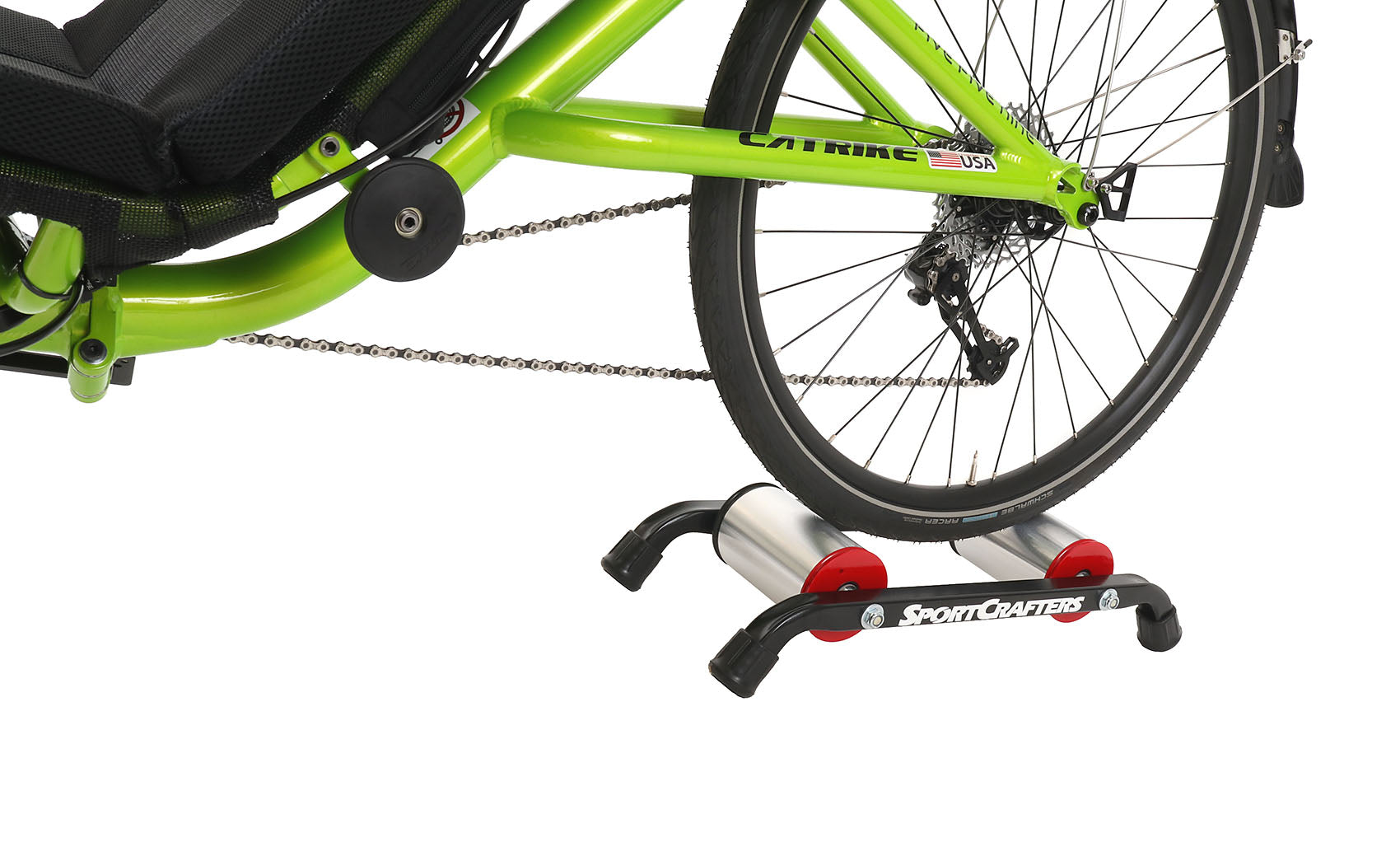 This is a side view of the SportCrafters Trike Trainer Double Overdrive, shown with a trike mounted, on a white background.