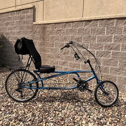 Side view of the Sun Seeker Used EZ-Sport CX 26-20 Lemans Blue Recumbent Bike in an outdoor setting.