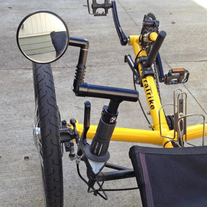 View of the T-Cycle Cockpit Mini T 3.75 inch without cable hole mounted on a recumbent trike handlebar with a mirror installed on it.