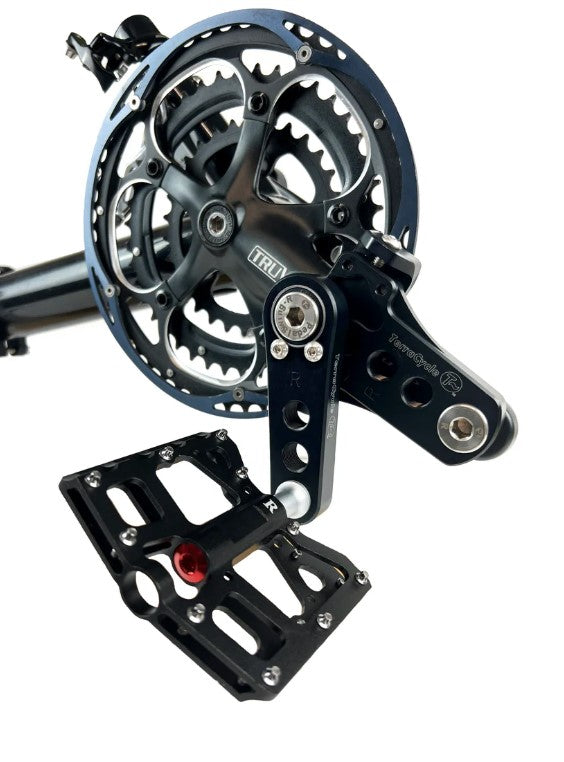 Right side view of T-Cycle Easy Knees Pedal Swing with crank shortners installed on a trike with black pedals. 