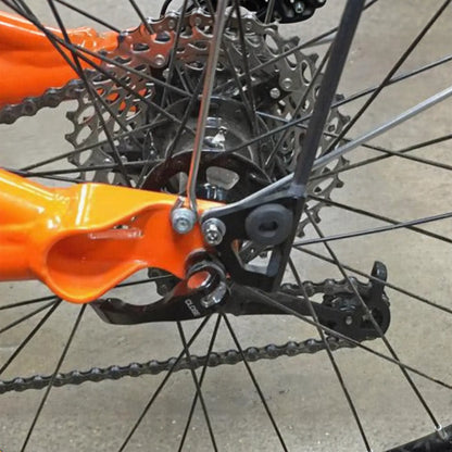 Closeup view of the T-Cycle Flag Grommet For Catrike Flag Mount in black mounted on a flag mount on an orange Catrike recumbent trike.
