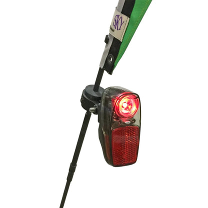 Closeup view of the T-Cycle Rubber Light Mount for Flags in black mounted on a flag pole with a bicycle taillight attached to it against a white background.