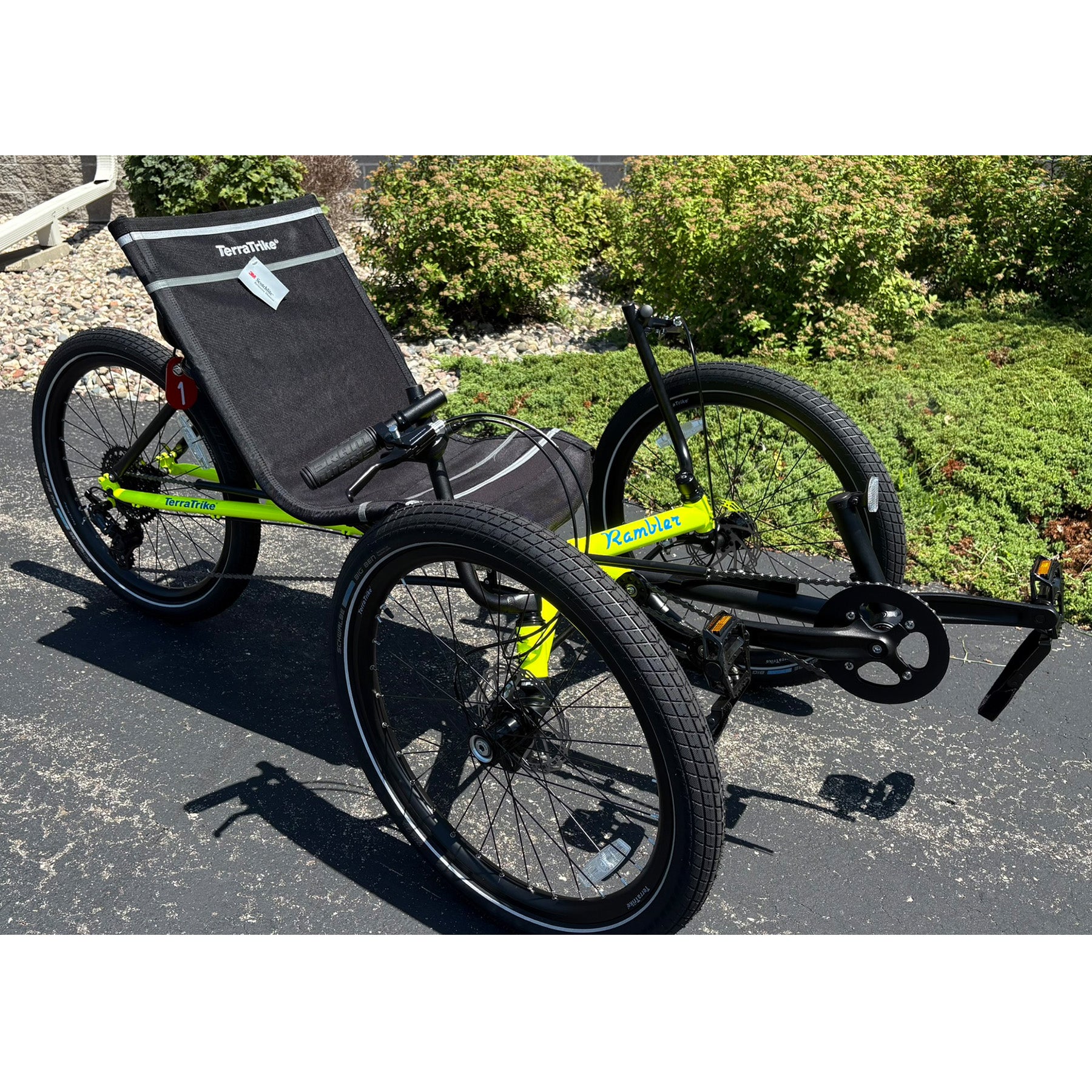 Angled view of the Terratrike Demo Rambler Recumbent Trike in Salted Grass in an outdoor setting.