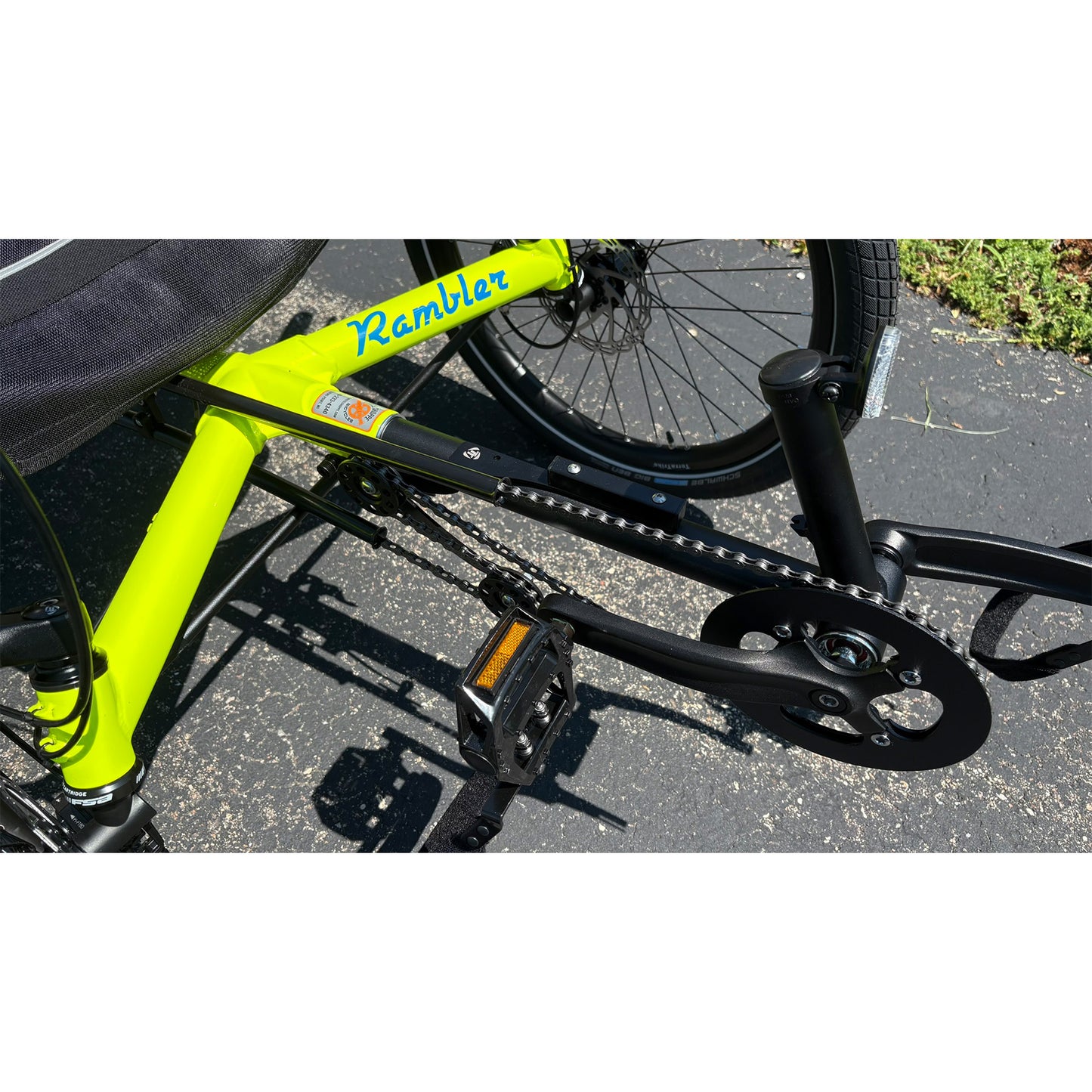 Closeup view of the Terratrike Demo Rambler Recumbent Trike in Salted Grass in an outdoor setting.