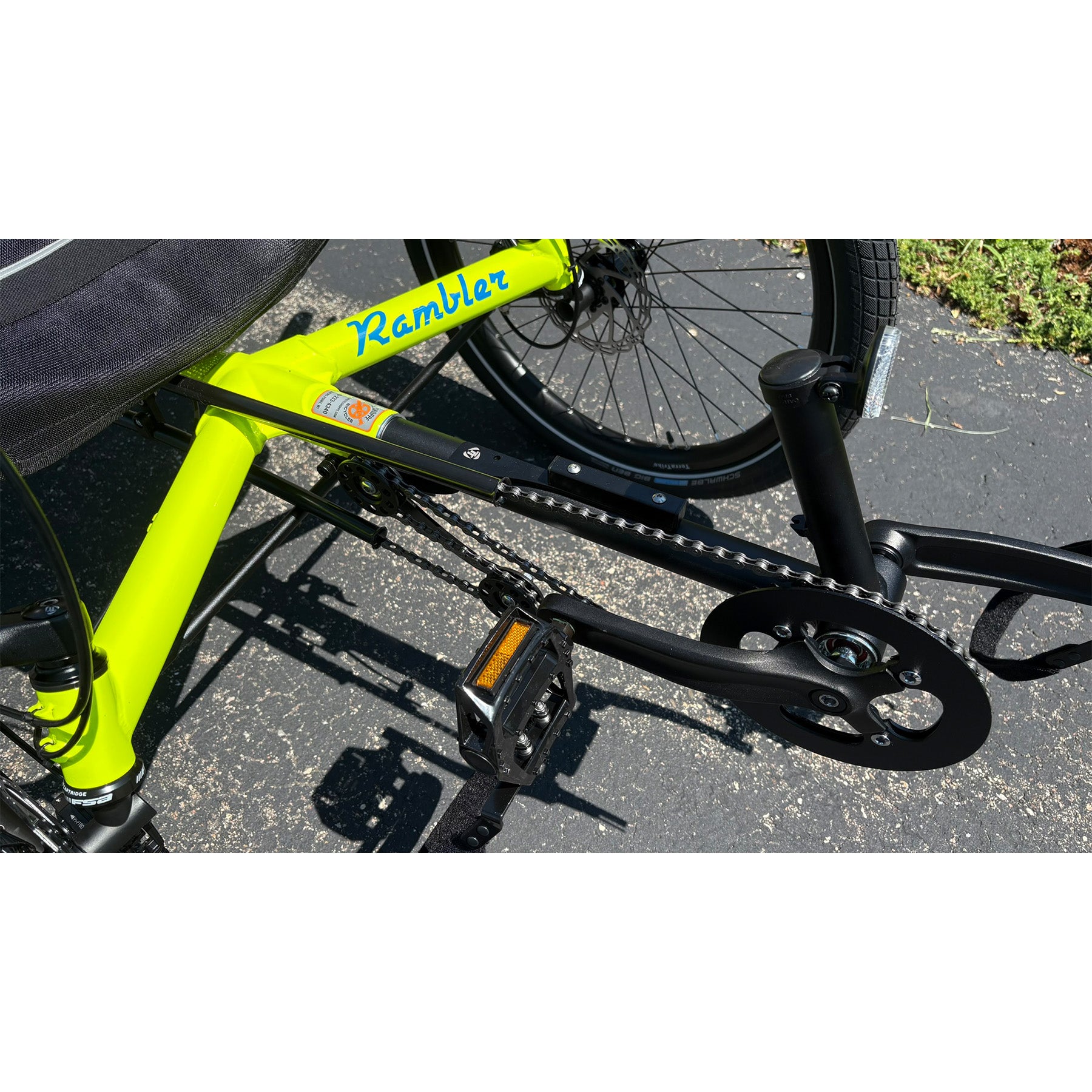 Closeup view of the Terratrike Demo Rambler Recumbent Trike in Salted Grass in an outdoor setting.