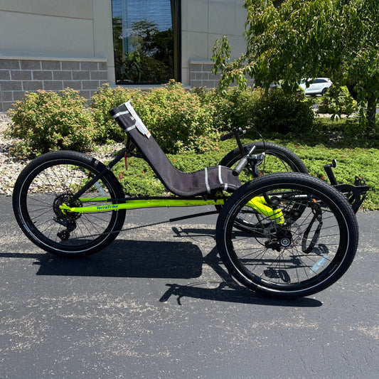 Side view of the Terratrike Demo Rambler Recumbent Trike in Salted Grass in an outdoor setting.