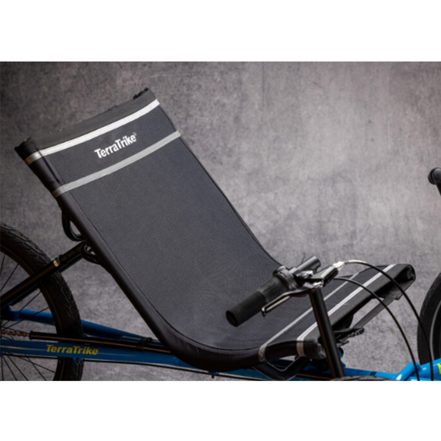 Closeup view of the seat on the TerraTrike Maverick Eiffel Blue Recumbent Trike against a grey background.