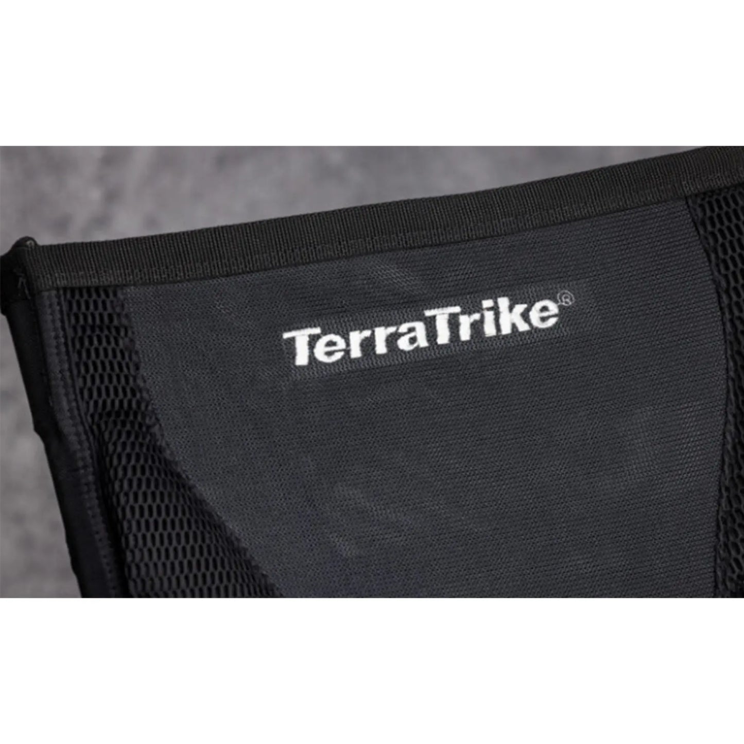 Close-up view of the Mesh seat with "TerraTrike" logo on the TerraTrike Rambler E-Plus Recumbent Trike in Gemstone against a grey background.
