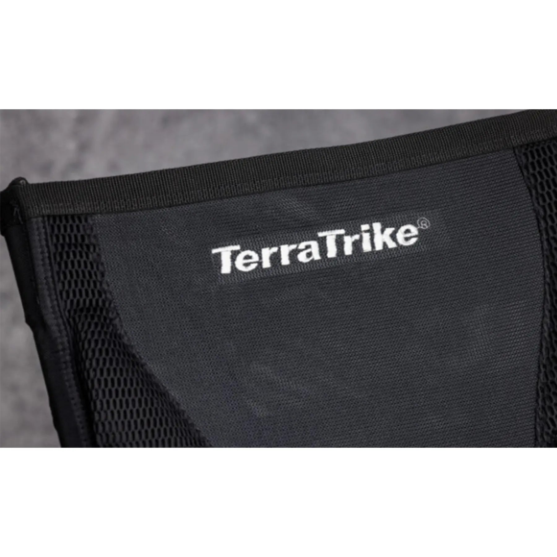 Close-up view of the Mesh seat with "TerraTrike" logo on the TerraTrike Rambler E-Plus Recumbent Trike in Gemstone against a grey background.