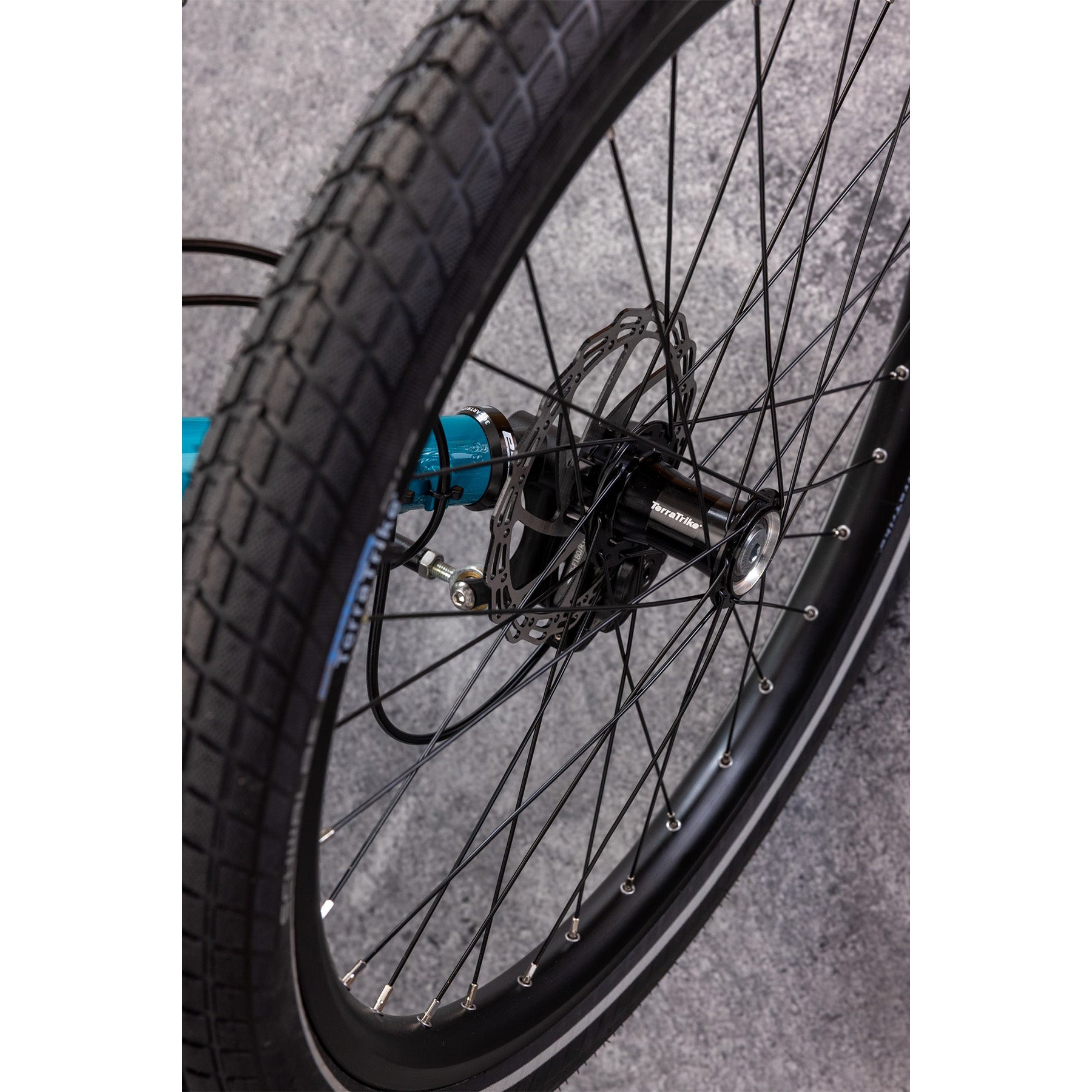 Wheel closeup on the Terratrike Rambler Recumbent Trike in Gemstone. 