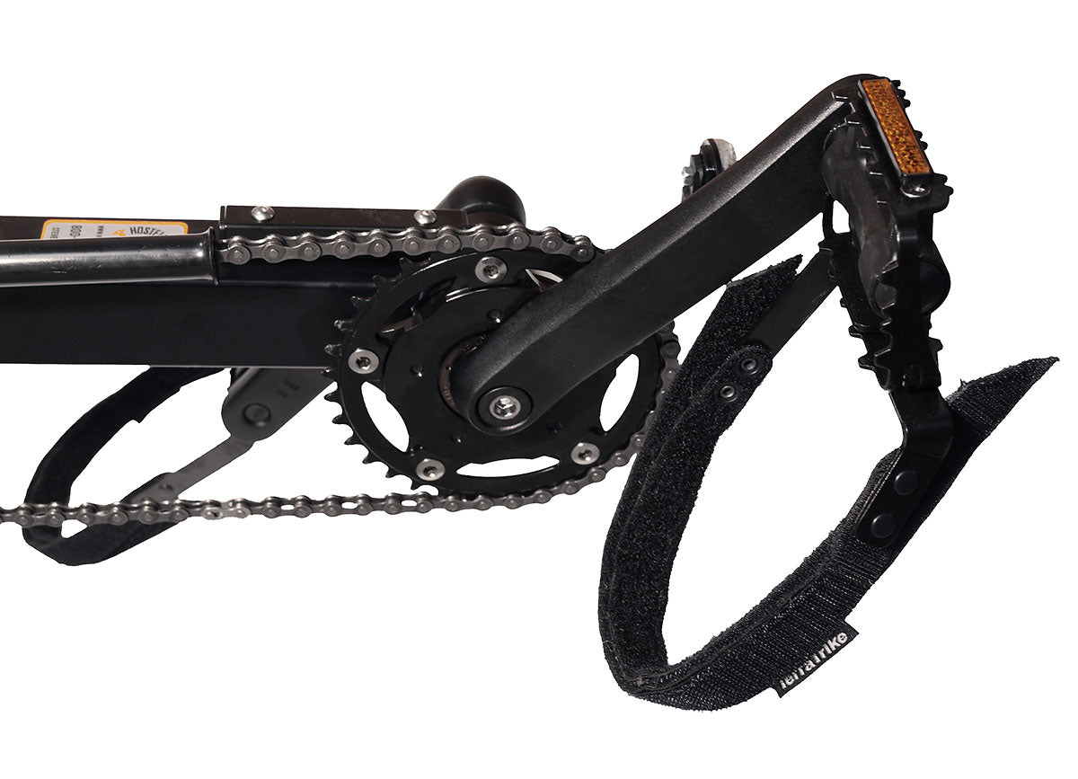 Closeup front view of the pedals and Comfort Heel Straps on the TerraTrike Rover Tandem Recumbent Trike in Habanero Orange against a white background.