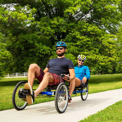 Two riders ride a blue Rover Tandem down a bike path. (Blue is discontinued.)